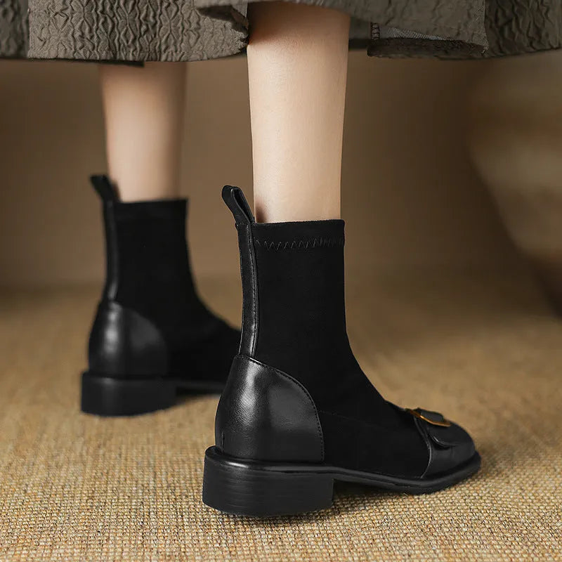 Women's black casual Martin ankle boots with lace-up front and buckle stitching detail on a low heel.