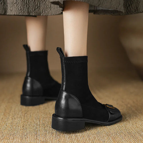 Women's black casual Martin ankle boots with lace-up front and buckle stitching detail on a low heel.