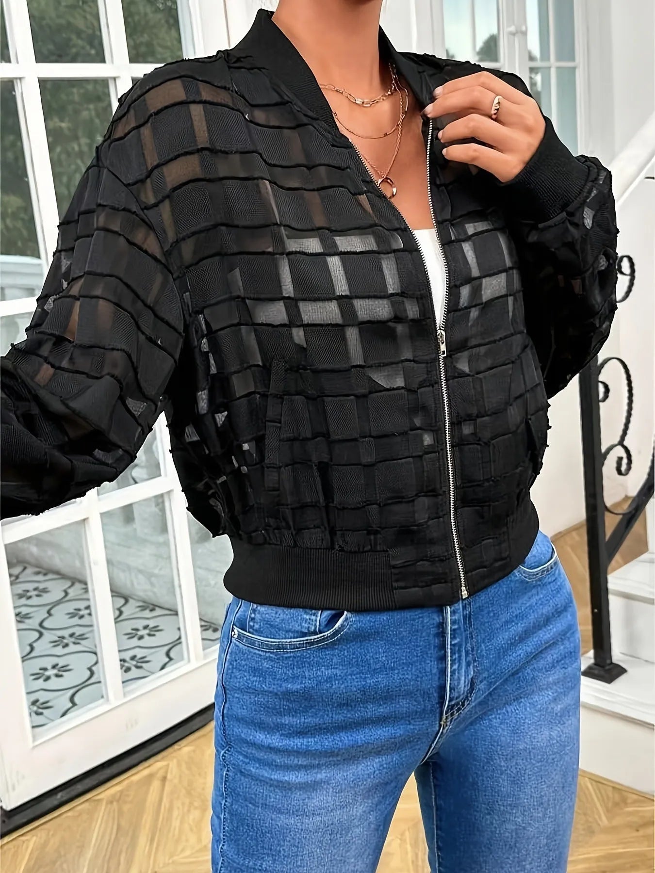 Black women's casual jacket with a geometric pattern, semi-transparent polyester fabric, and a thread zipper.