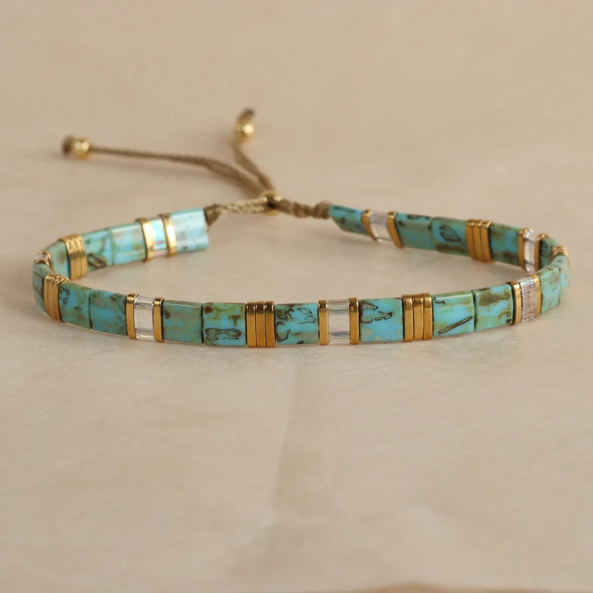 Geometric beaded pull-on bracelet in milky white, black, green, blue, or red colours