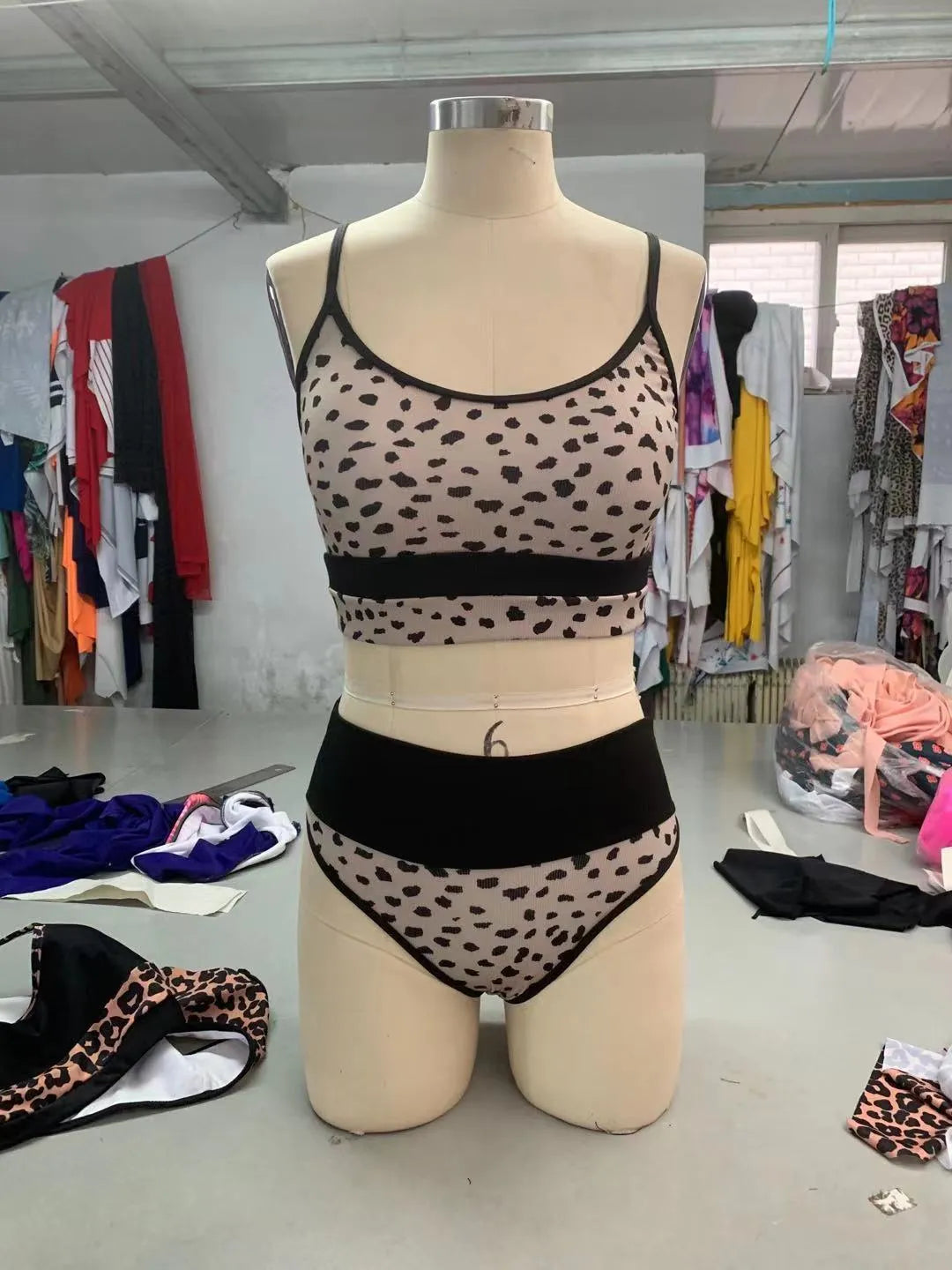 Women's high waist split bikini swimsuit in white and leopard print options with nylon fabric