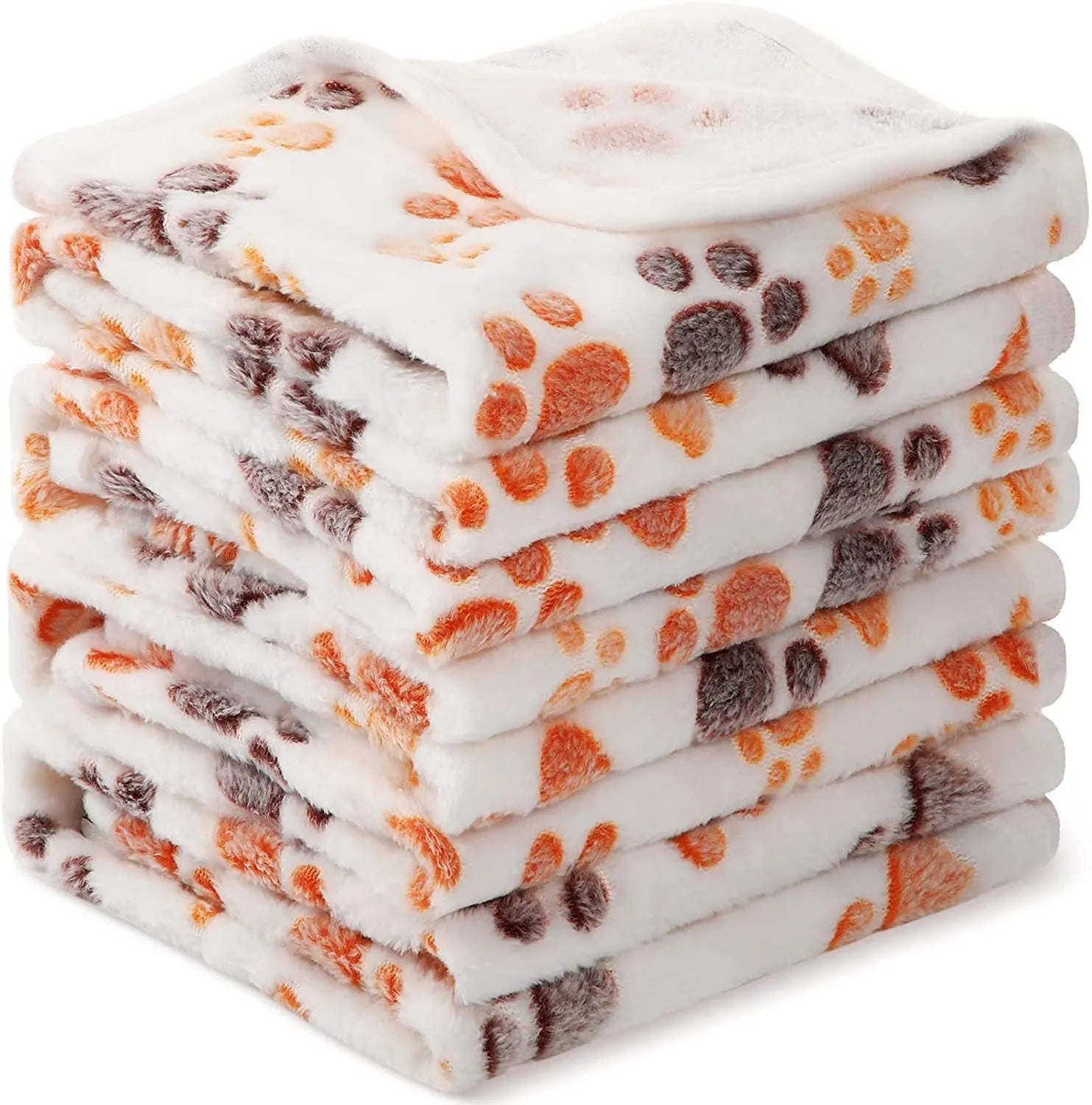 Coral fleece dog blanket with paw print pattern in beige, shown in a large size on a dog bed.