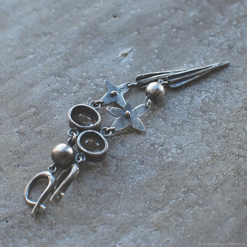 Pair of Hesheng geometric long drop earrings with antique silver XINGX pendant and rhinestones.