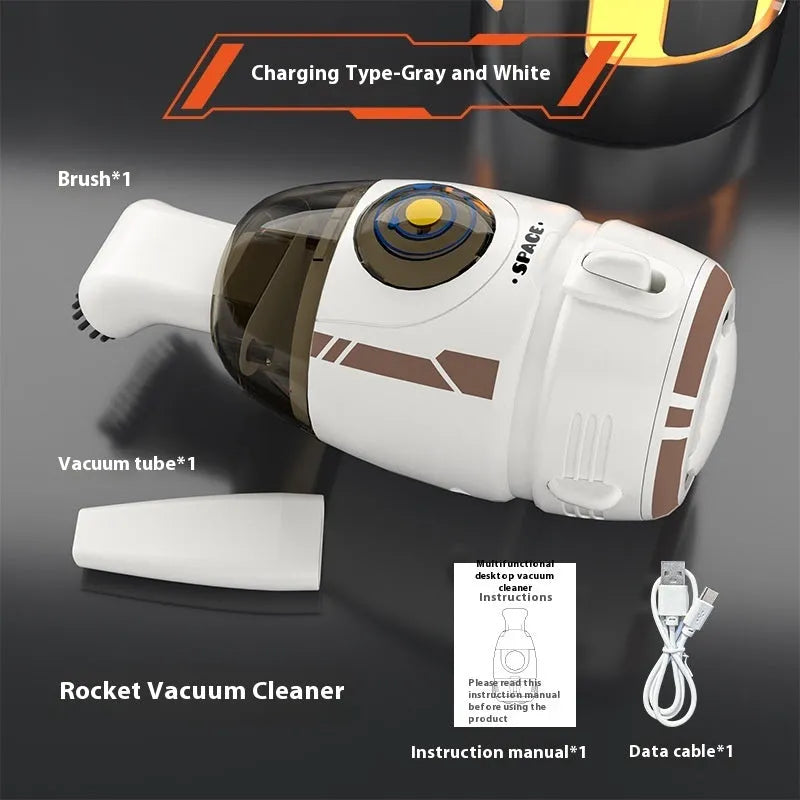 USB charging handheld desktop vacuum cleaner in blue rocket design on computer keyboard