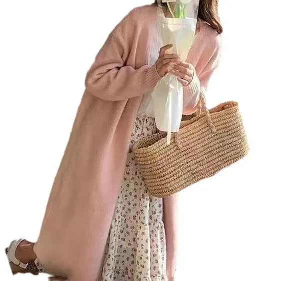 Women's knitted V-neck cardigan in loose fit showing mid-length silhouette and long sleeves