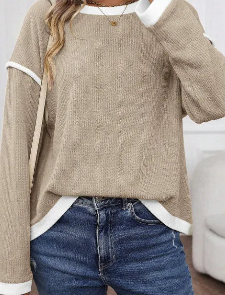 Women's beige knit top with four leaf clover pattern, contrast trim, and drop shoulder loose fit