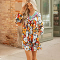 Orange women's mini dress with floral striped print and lace detailing, featuring a V neck and long sleeves.