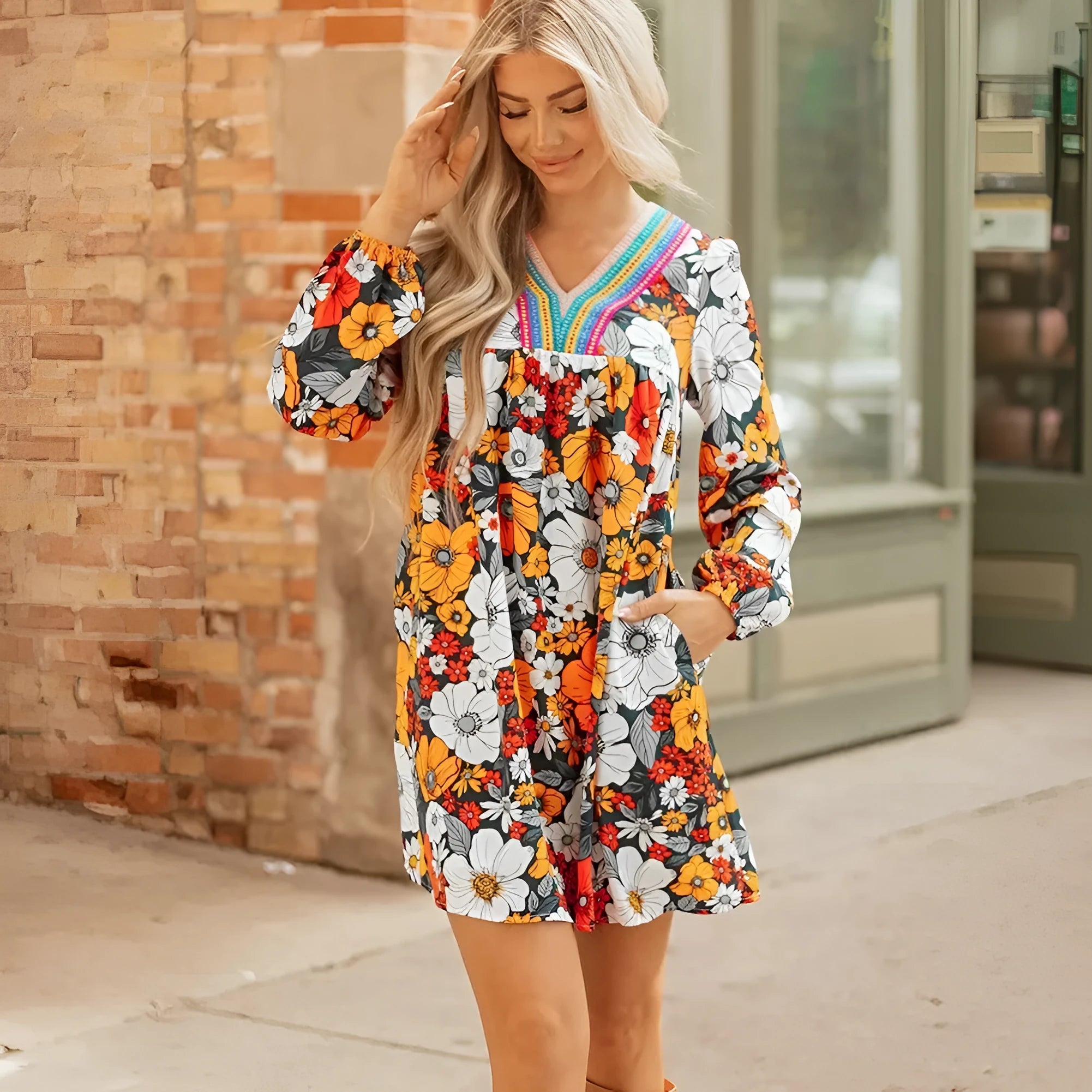 Orange women's mini dress with floral striped print and lace detailing, featuring a V neck and long sleeves.