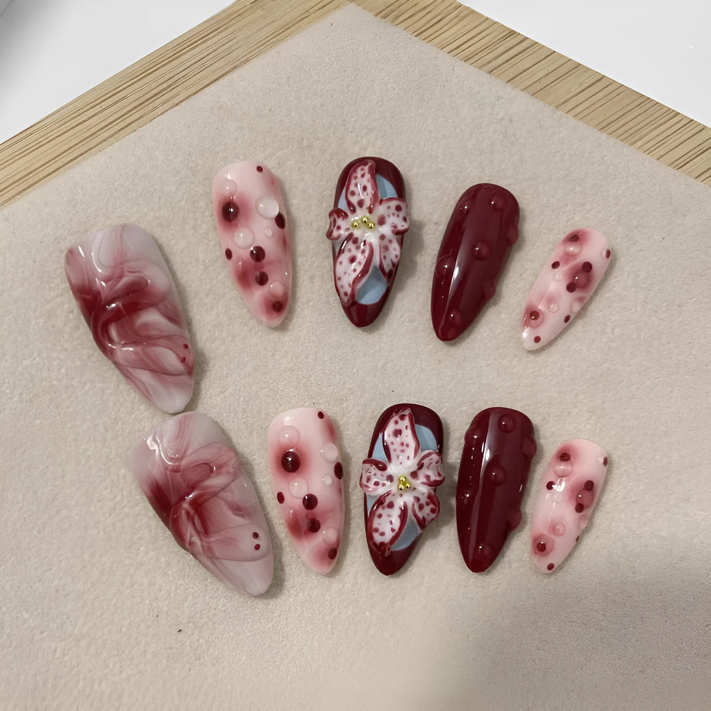 Hand-painted 3D carved artificial nails with floral designs on almond-shaped tips