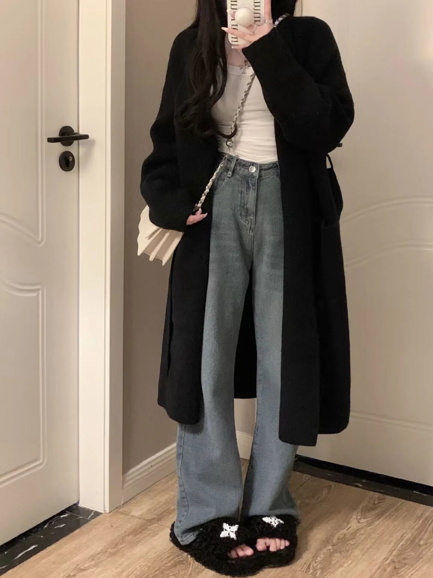 Women's knitted V-neck cardigan in loose fit showing mid-length silhouette and long sleeves