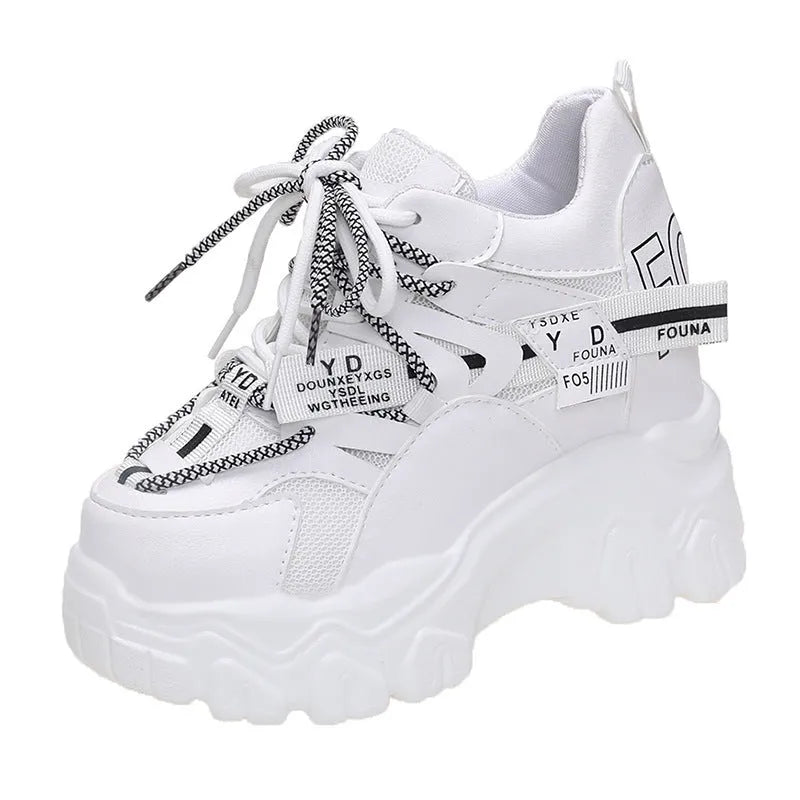 White and black women's low-top mesh platform sports shoes with cross strap and round toe.