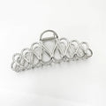 Large alloy hair clip with tassel design in gold electroplated finish for women's updo styling
