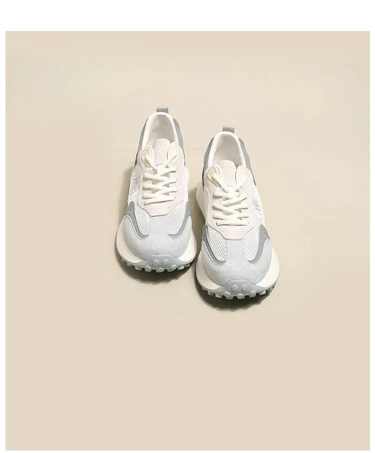 Women's grey retro sneaker with round toe and rubber sole showing mesh lining interior