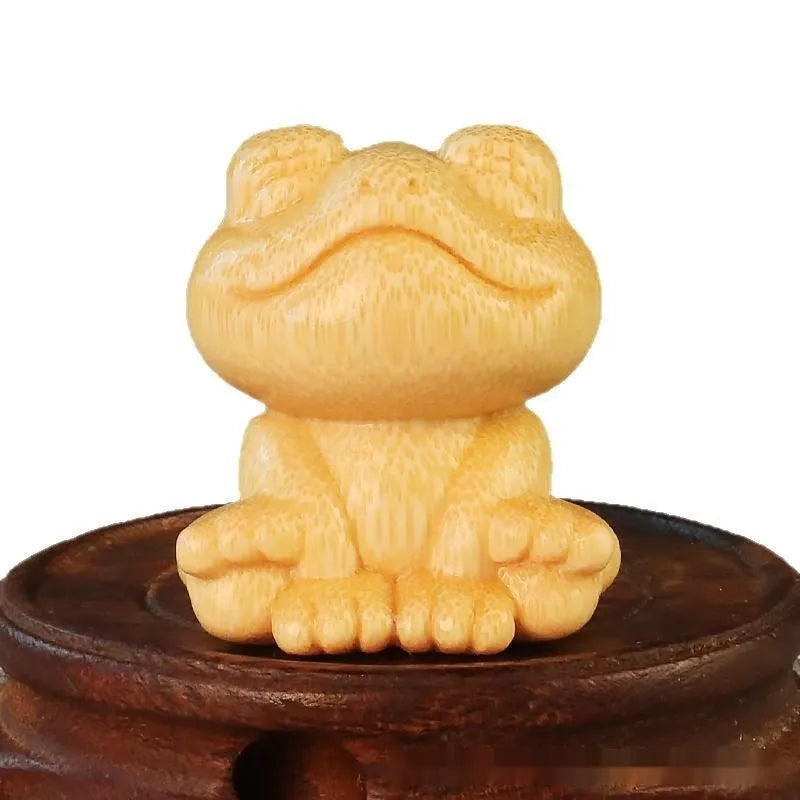 Small smiling frog ornament carved from solid bamboo measuring 5cm in height