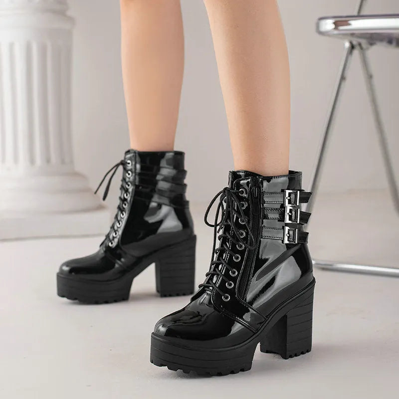 Women's black thick-heeled lace-up ankle boots with a round toe and rubber sole on a waterproof platform.