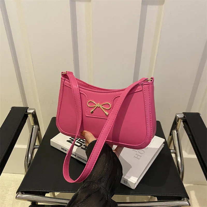 Western style PU leather shoulder bag with bow detail in horizontal square shape.