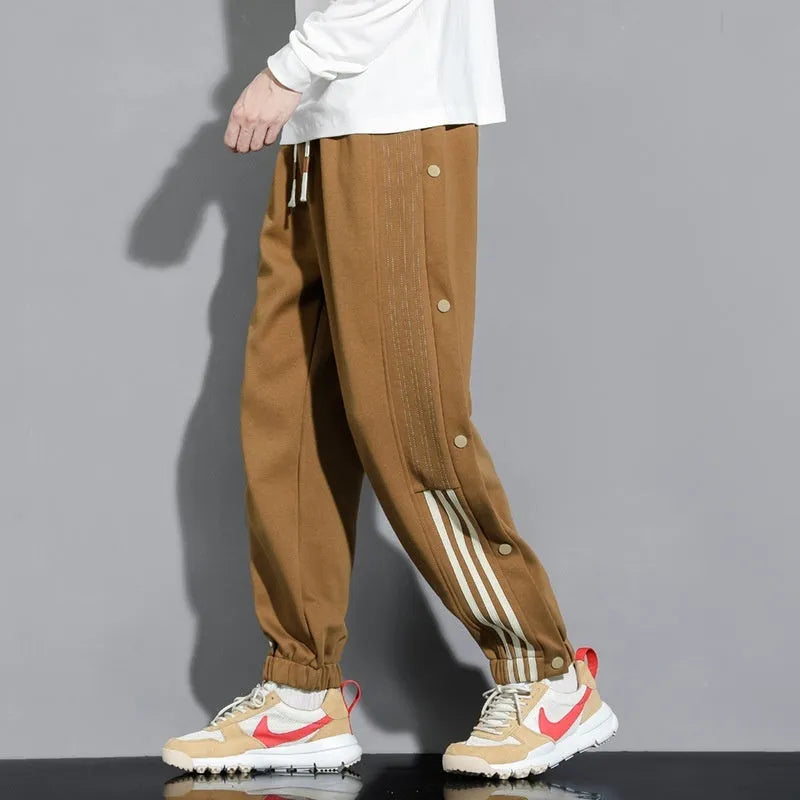 Men's loose fit cotton blend sports pants with high waist and ankle-tied cuffs in solid colours