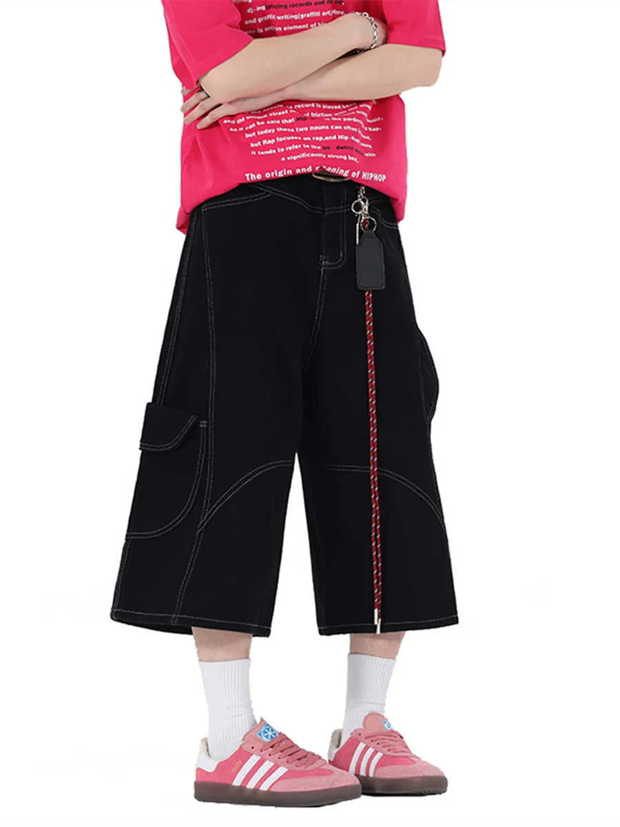 Red retro denim shorts with wide leg and multiple pockets laid flat.