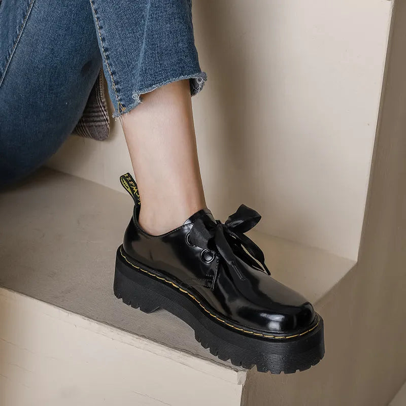 Women's white thick-soled lace-up shoes with ribbon and cross-strap details on a superfine fibre upper.