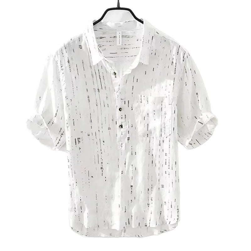 A man's loose-fitting black lapel polo shirt with short sleeves on a hanger.