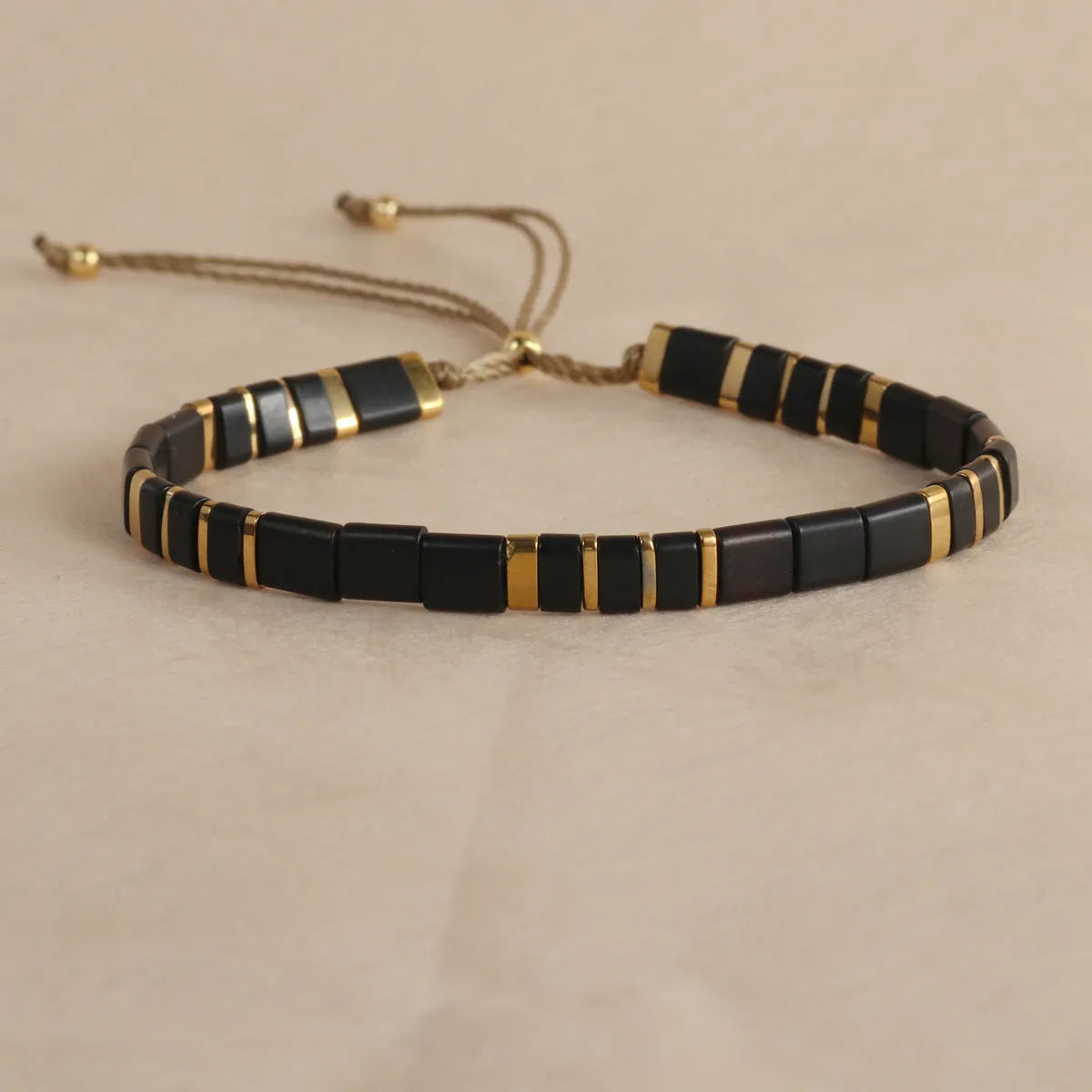 Geometric beaded pull-on bracelet in milky white, black, green, blue, or red colours