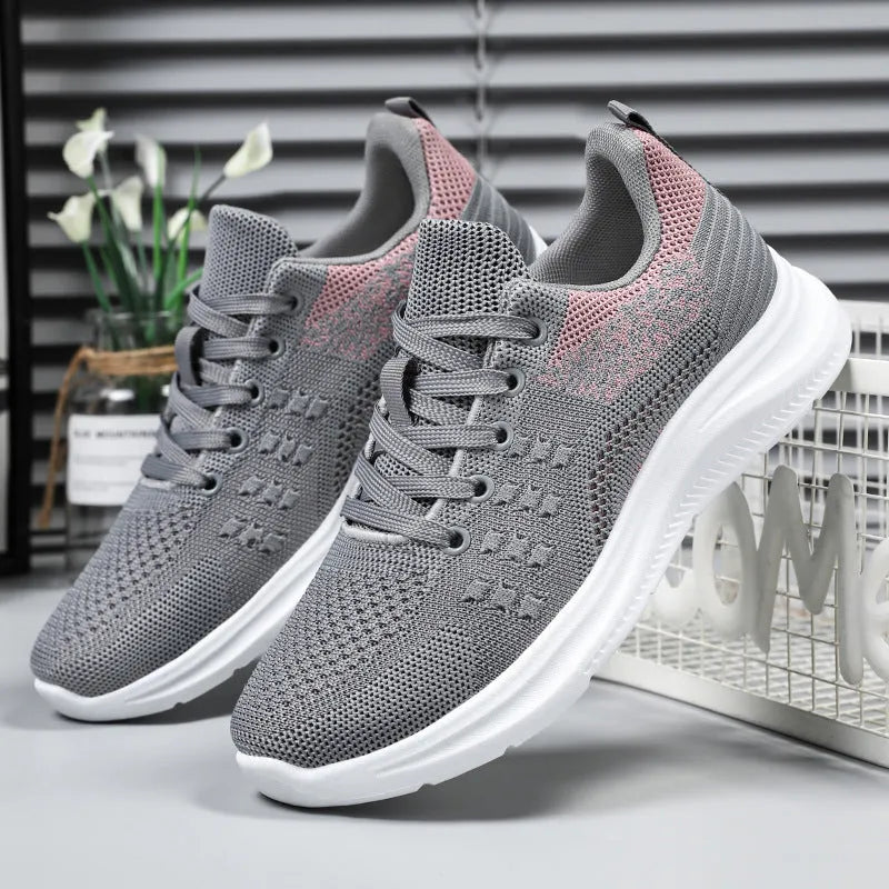 Women's black mesh sneakers with round toe and lace-up design on white background