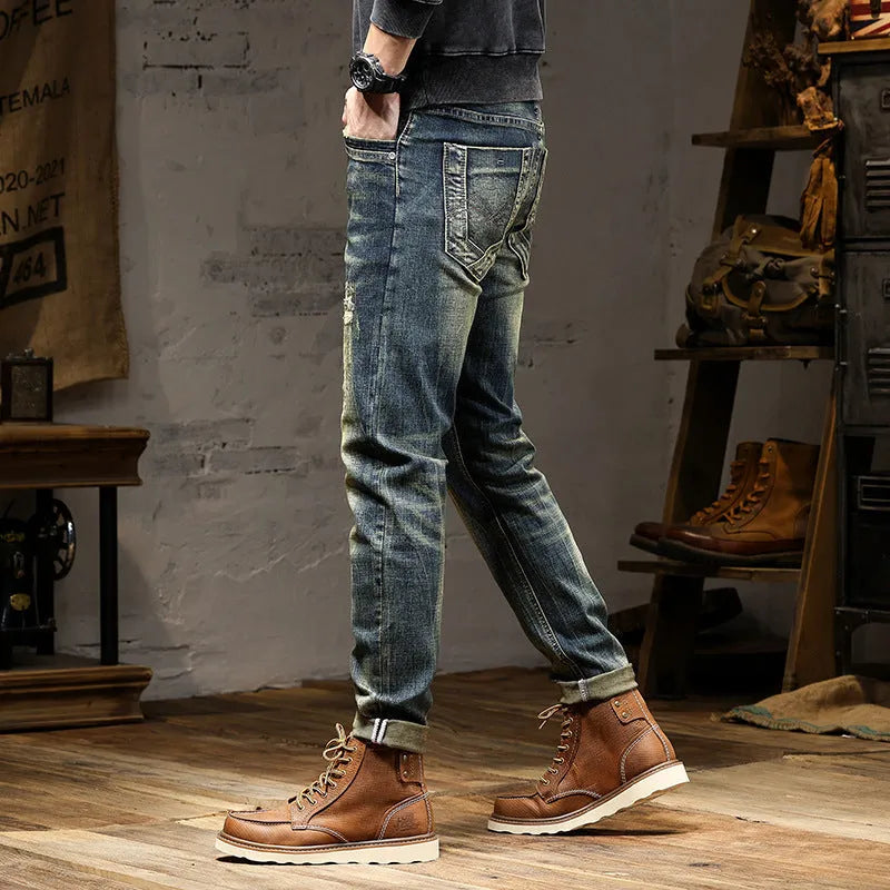 Man wearing skinny fit retro blue jeans with a zip fly, showcasing the casual pencil pants style.