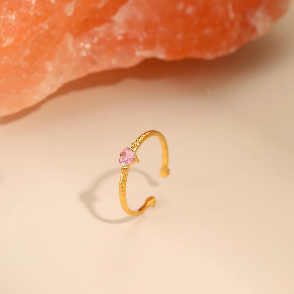 Open-ended stainless steel ring featuring a geometric heart shape with an inlaid zircon stone.