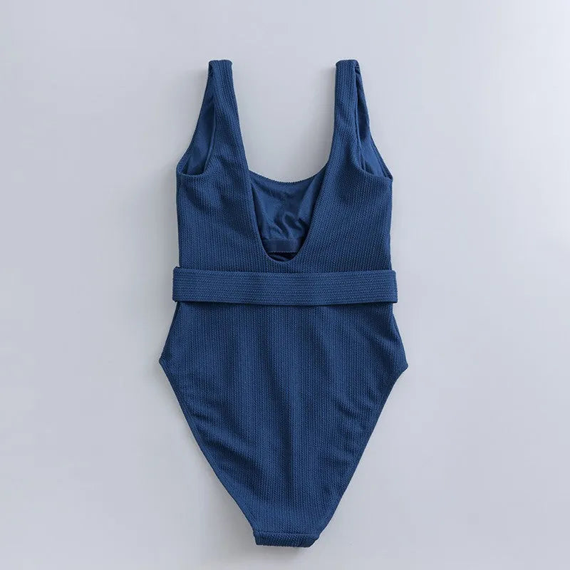 Navy blue women's one-piece slimming swimsuit with triangle top and chest pads on a white background.