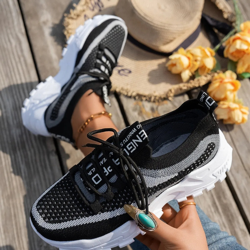 Women's Flyknit mesh lace-up sneakers in multiple colours on a rubber sole.
