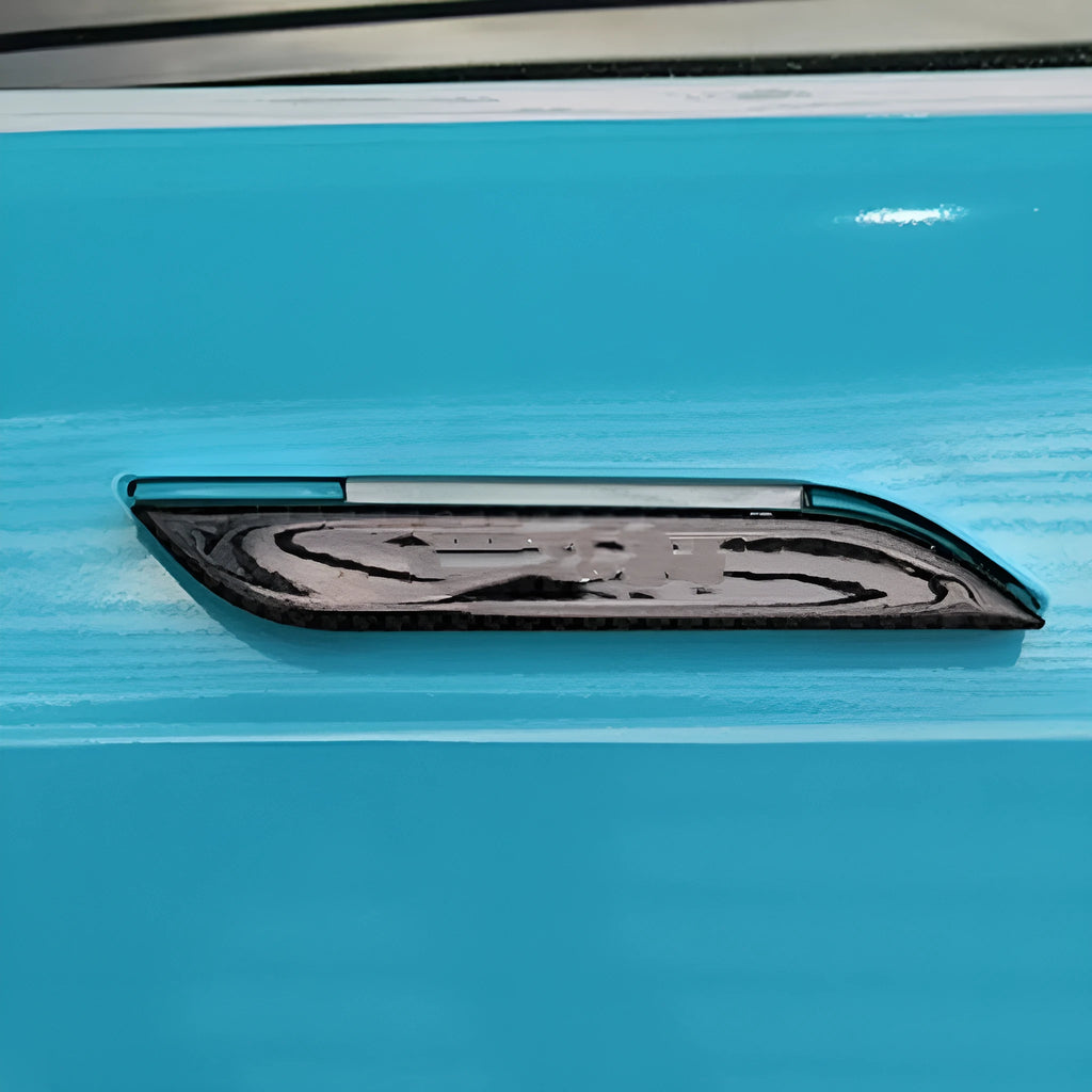 Four carbon fibre adhesive door handle protection stickers for Tesla Model S interior.
