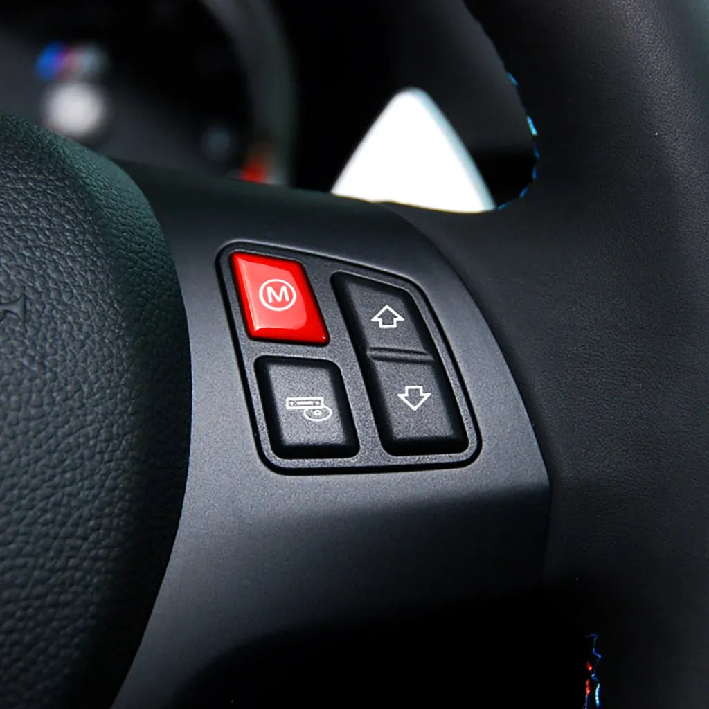 Pair of red and blue BMW steering wheel M1 and M2 mode replacement buttons on a white background.