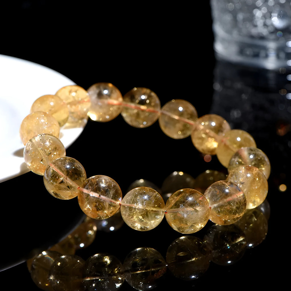 A natural yellow citrine beaded bracelet with geometric stones on a wrist, showing single circle design.