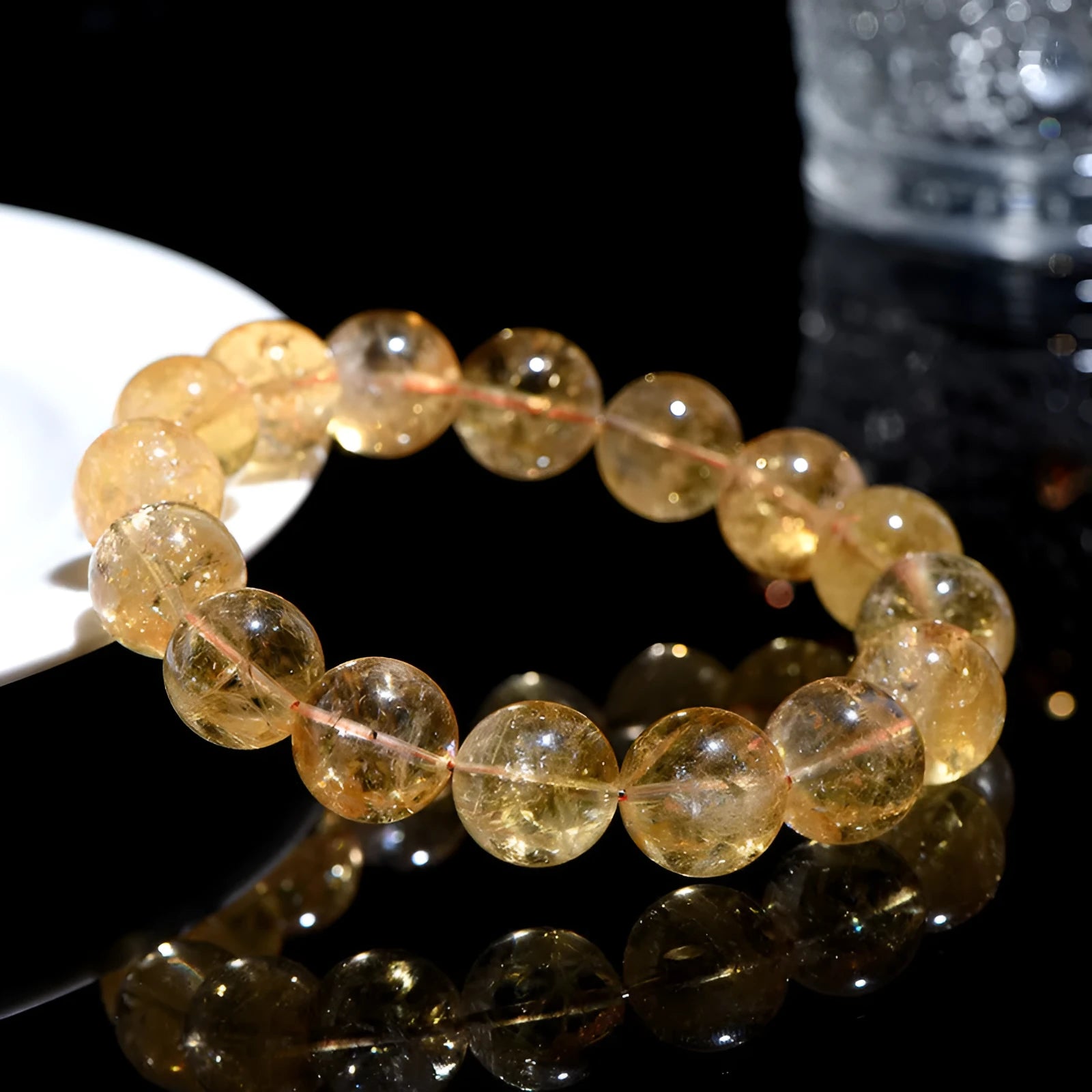 A natural yellow citrine beaded bracelet with geometric stones on a wrist, showing single circle design.
