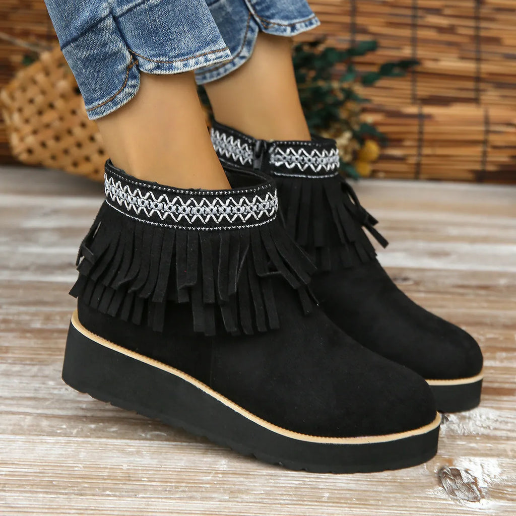 Women's dark brown suede wedge bootie with thick sole, side zipper, and tassel detail.