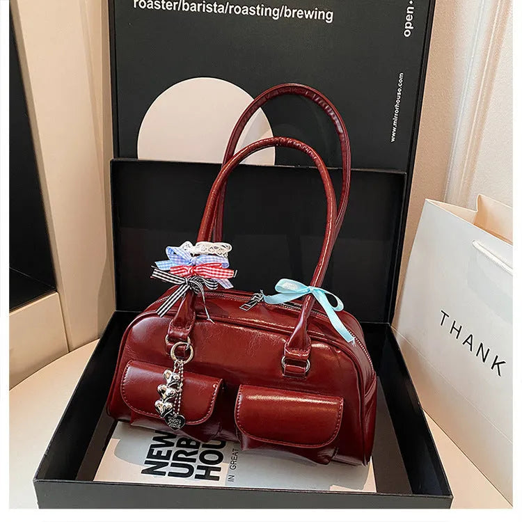 Retro brown PU leather women's shoulder bag with pillow-shaped design and double strap.