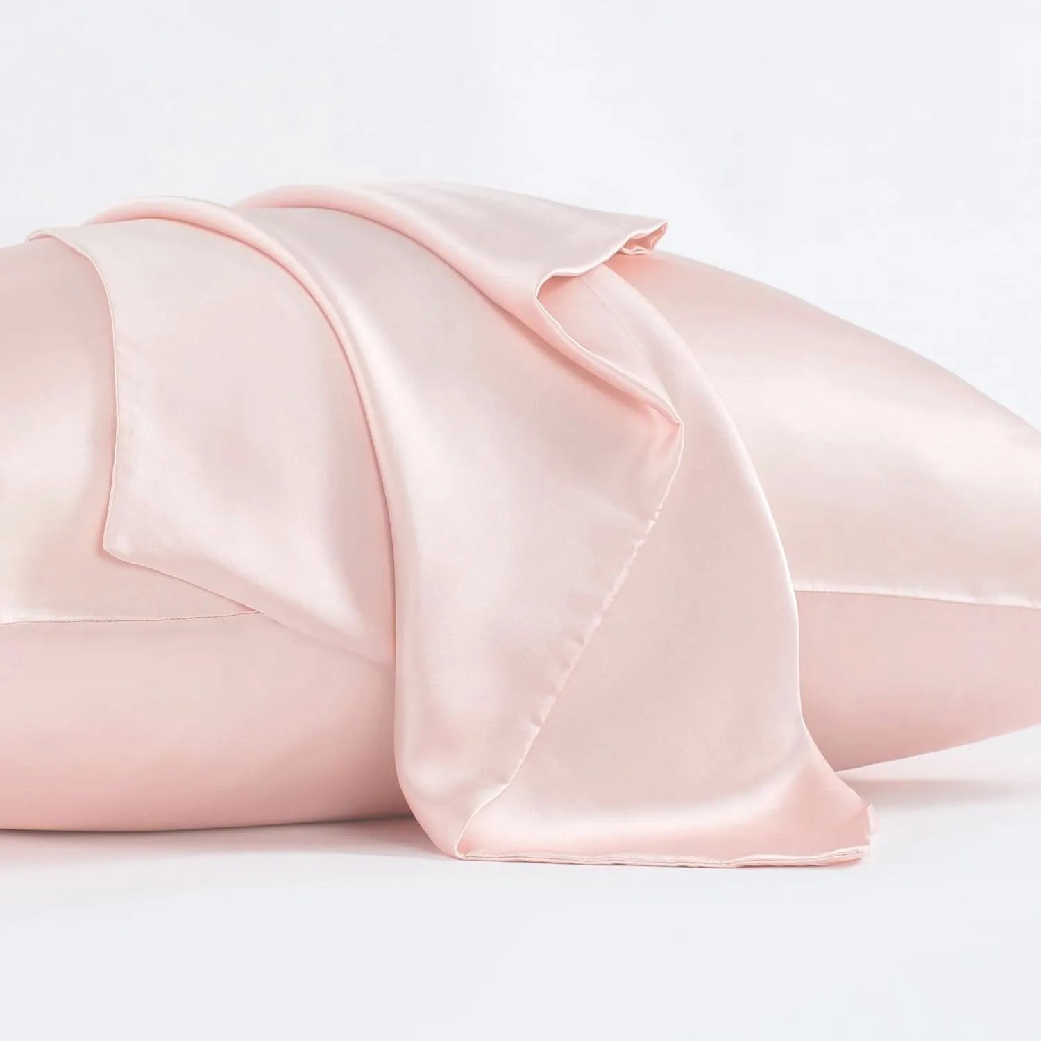 Dark grey silk pillowcase with envelope closure, shown flat and on a pillow.