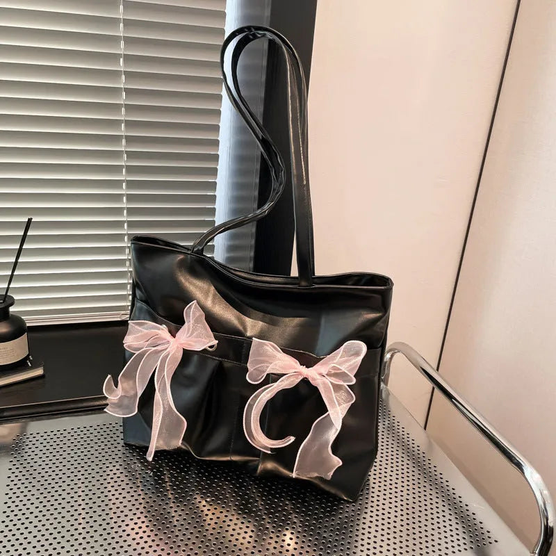 Black college-style bow tote bag with double shoulder straps and zippered compartment