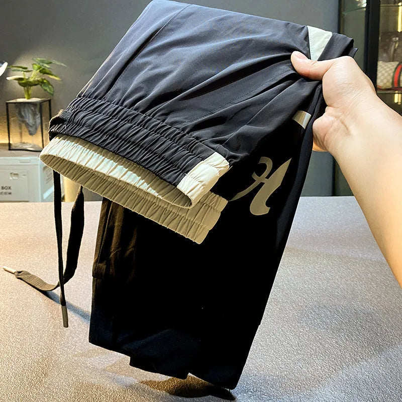 Black men's ultra-thin cotton cropped trousers with elasticated ankle banding.