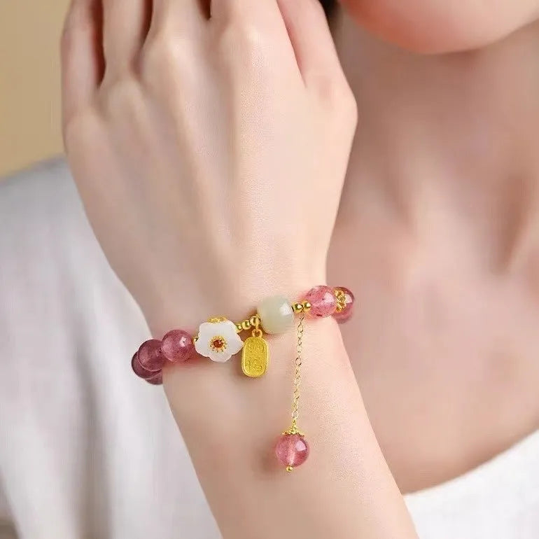 Adjustable strawberry quartz bracelet with Hetian jade peach blossom charm on wrist