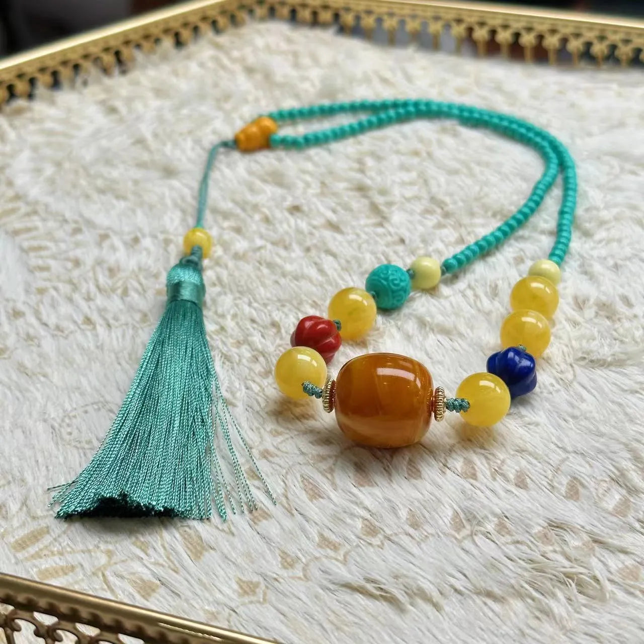 Hand-woven turquoise mesh flower lucky pendant on a ball bead necklace chain, adjustable length.