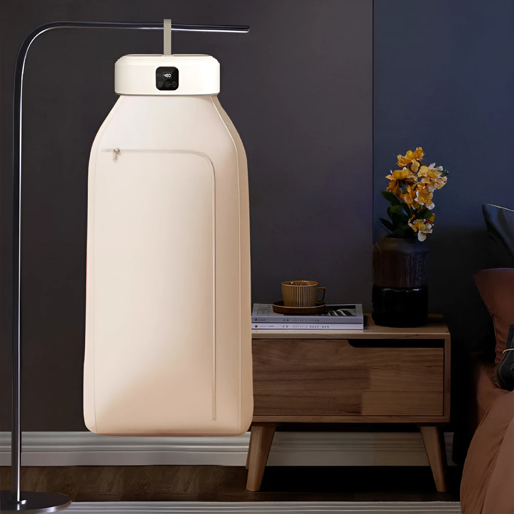 White foldable portable clothes dryer with remote control on countertop