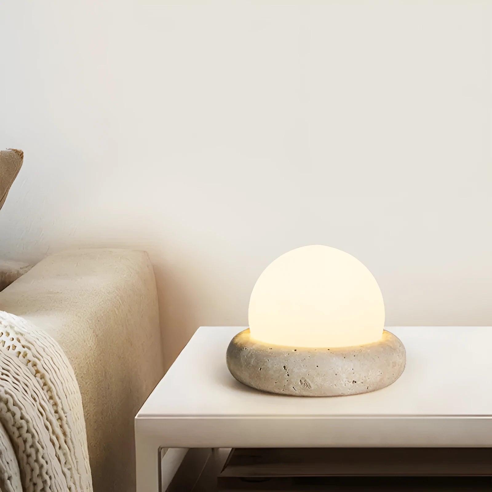Cream modern bedside remote control night lamp with yellow cave stone light on bedside table