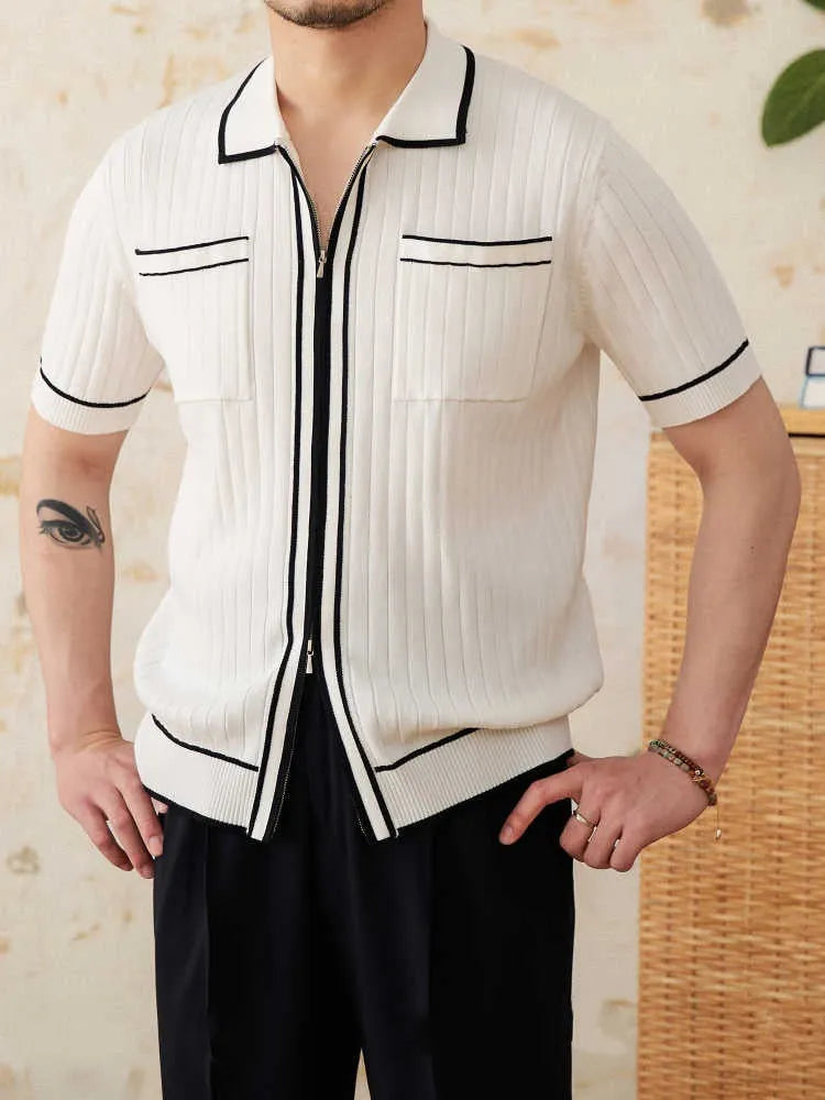 Man's slim fit black knitted polo shirt with lapel collar and short sleeves on a hanger.