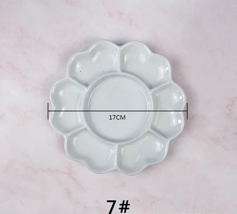 White ceramic plum blossom shaped artist's palette for paint mixing