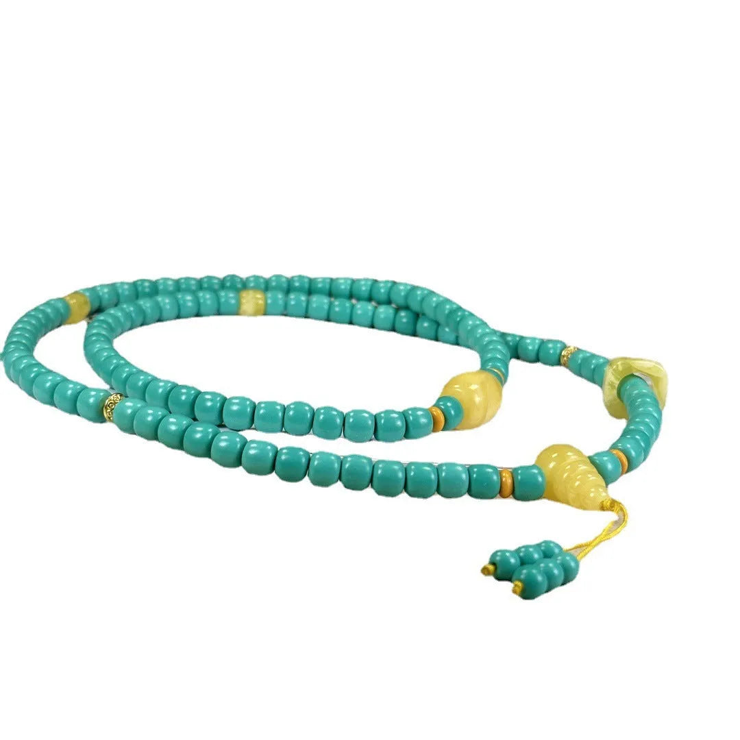 Hand-woven turquoise mesh flower lucky pendant on a ball bead necklace chain, adjustable length.