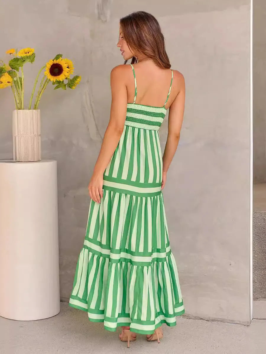 A woman wearing a striped backless suspender summer dress with a square neckline and side pockets.