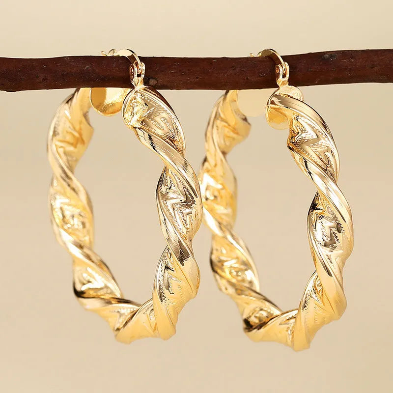 Women's geometric drop earrings with clip-on fastening in copper with ring and line design elements