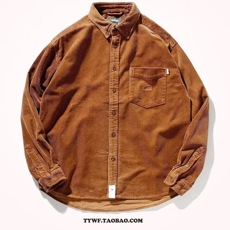 A man wearing a caramel coloured corduroy long sleeve cardigan shirt with a loose fit and button front.