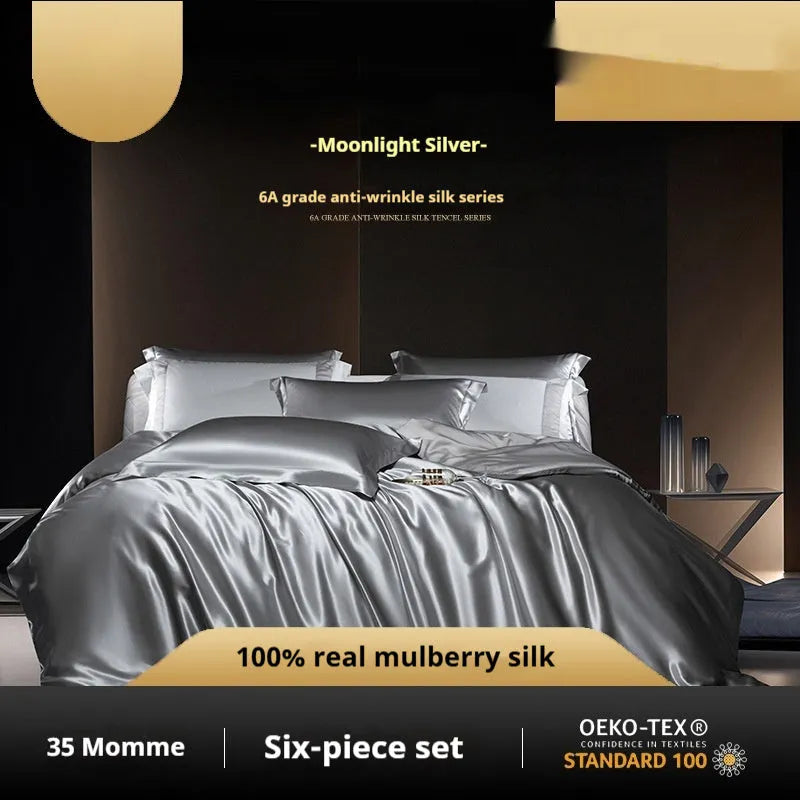 Solid colour silk quilt cover set on a bed in champagne gold, showing flat sheet and pillowcases.
